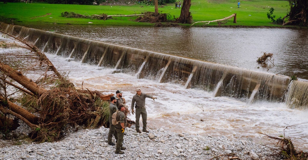 A K-9 unit with the Texas Game Wardens conducts a search amid flood damage near Camp Mystic in Kerr County, Texas on Saturday.