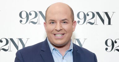CNN's Brian Stelter, seen here on Nov. 14, 2023, in New York City with a backdrop that says "92NY"