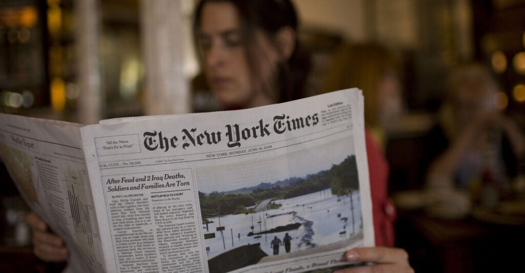 A woman reads The New York Times
