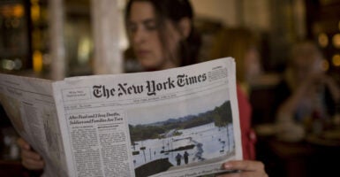 A woman reads The New York Times