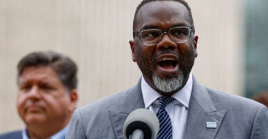 Chicago Mayor Brandon Johnson speaks at a press conference Monday as Illinois Gov. JB Pritzker looks on. Both Democrats strongly rejected any move by President Donald Trump to send National Guard troops to Chicago to fight crime.