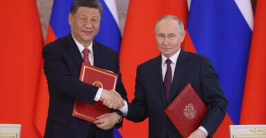 Russian President Vladimir Putin greets Chinese President Xi Jinping during a meeting at the Grand Kremlin Palace in Moscow on May 8.