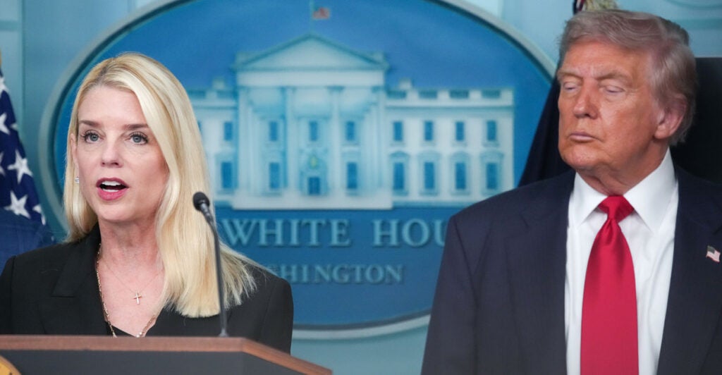 Attorney General Pam Bondi speaks from White House podium, with President Trump looking on beside her.