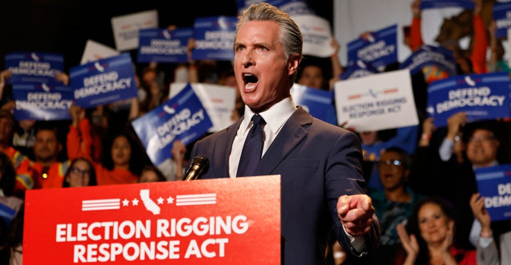 Gavin Newsom yells while standing behind podium reading "Election Rigging Response Act."