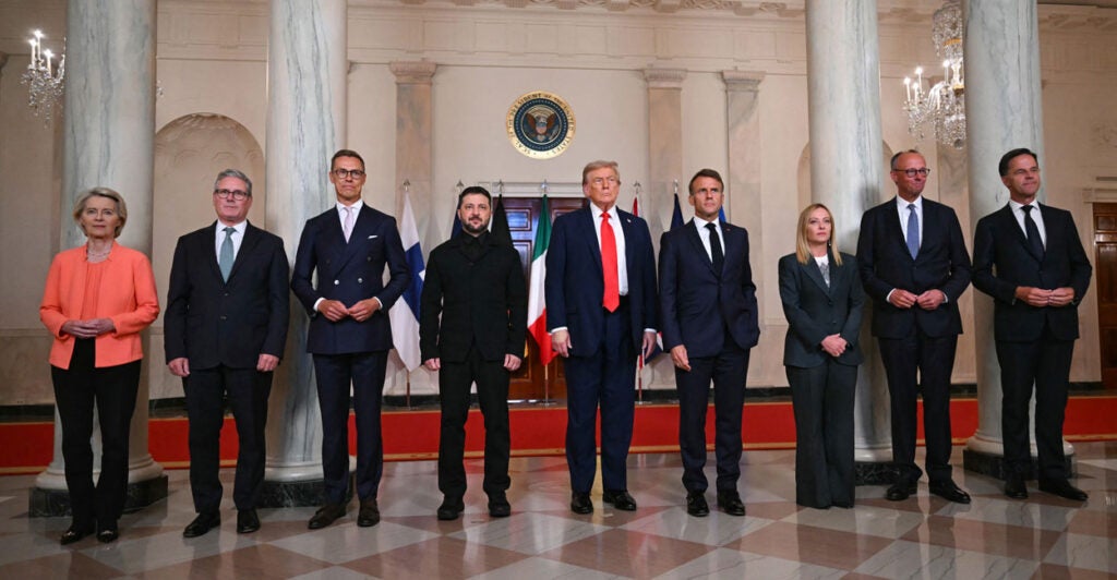 From left: European Commission President Ursula von der Leyen, British Prime Minister Keir Starmer, Finnish President Alexander Stubb, Ukrainian President Volodymyr Zelenskyy, President Donald Trump, French President Emmanuel Macron, Italian Prime Minister Giorgia Meloni, German Chancellor Friedrich Merz, and NATO Secretary-General Mark Rutte pose for a photo in the Cross Hall of the White House on Monday.