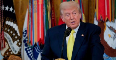 Donald Trump speaking at a podium