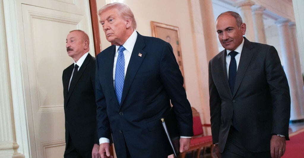 President Donald Trump arrives at a peace pact signing ceremony with Azerbaijani President Ilham Aliyev (left) and Armenian Prime Minister Nikol Pashinyan at the White House on Aug. 8.