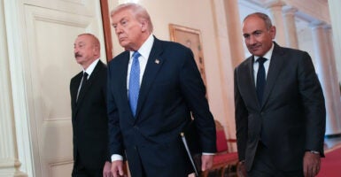 President Donald Trump arrives at a peace pact signing ceremony with Azerbaijani President Ilham Aliyev (left) and Armenian Prime Minister Nikol Pashinyan at the White House on Aug. 8.