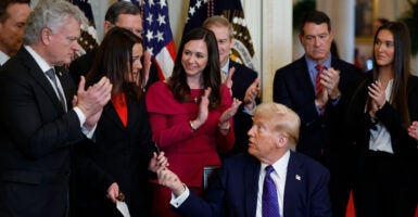 President Donald Trump hands a pen to Laken Riley's mother, Allyson, after using it to sign the Laken Riley Act into law on Jan. 29. (Chip Somodevilla/Getty Images)