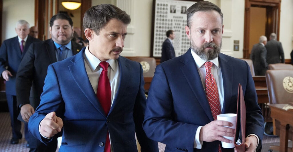 Texas state Rep. Briscoe Cain (left) and Speaker of the House Dustin Burrows leave a caucus meeting at the Capitol in Austin, Texas, on Aug. 8.
