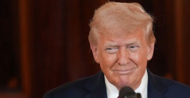 President Donald Trump in a suit smiles