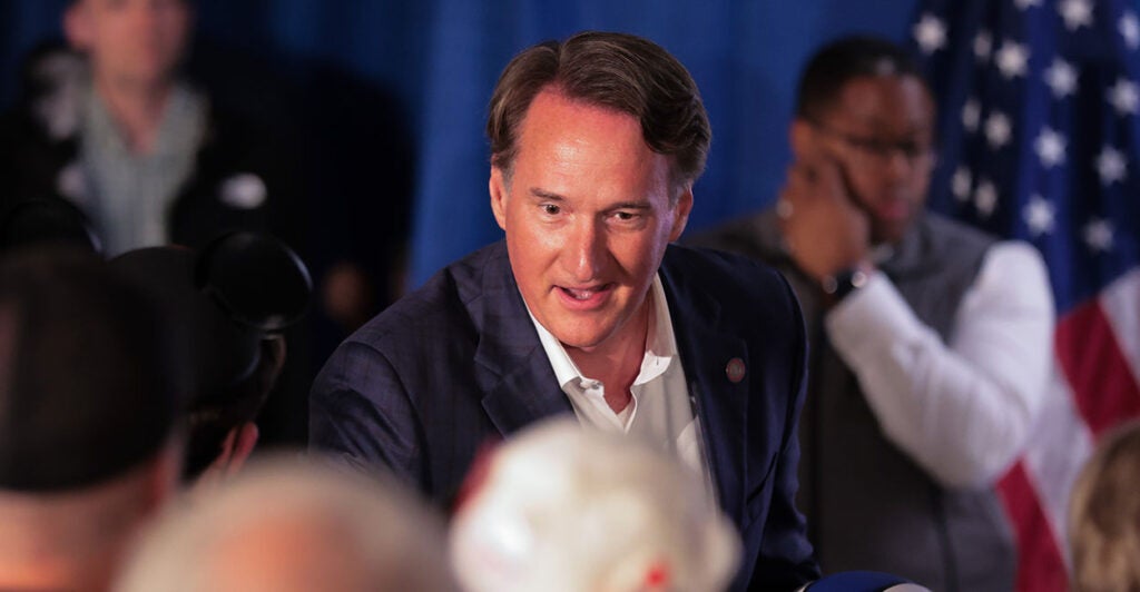 Glenn Youngkin shakes someone's hand at a Winsome Earle-Sears rally.