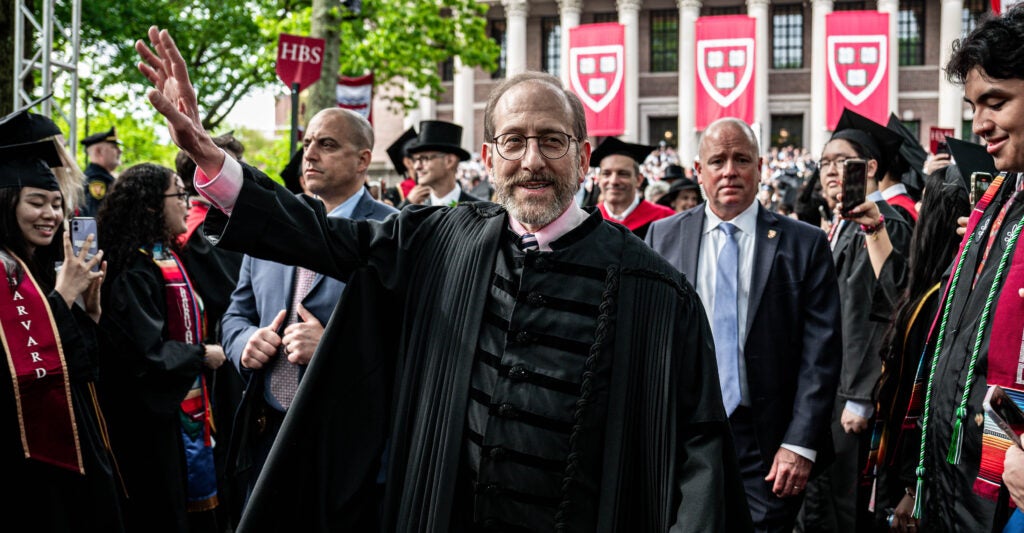 Harvard University President Alan Garber interacts with students during commencement ceremony at Harvard University in Cambridge, Massachusetts, the United States, May 29, 2025.