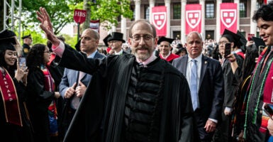 Harvard University President Alan Garber interacts with students during commencement ceremony at Harvard University in Cambridge, Massachusetts, the United States, May 29, 2025.