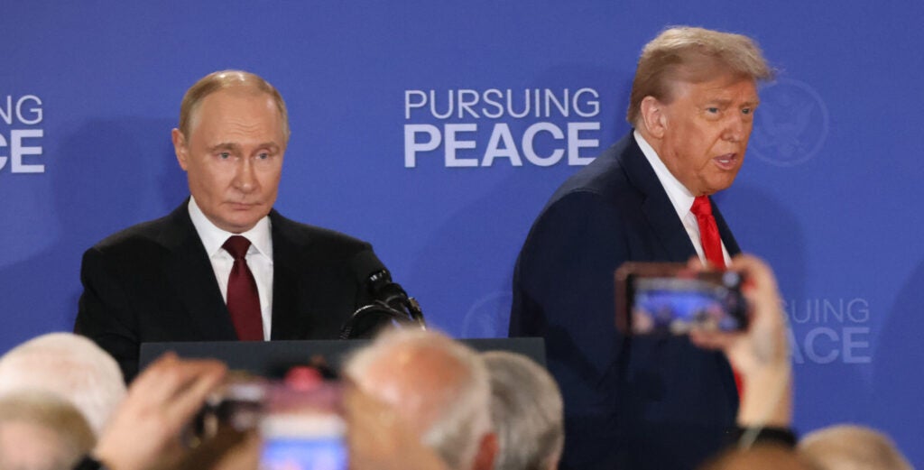 Russian President Vladimir Putin (left) and President Donald Trump enter the hall for their joint press conference after their meeting on the Russia-Ukraine war at a U.S. air base In Alaska on Friday.