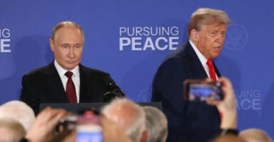 Russian President Vladimir Putin (left) and President Donald Trump enter the hall for their joint press conference after their meeting on the Russia-Ukraine war at a U.S. air base In Alaska on Friday.