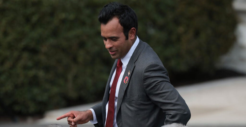 Ramaswamy looks to the side at a crowd sporting an OSU pin.,