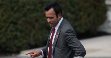 Ramaswamy looks to the side at a crowd sporting an OSU pin.,