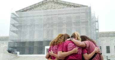 A group of women pray outside the US Supreme Court, on the final day of the Court's term, in Washington, DC, on June 27, 2025.