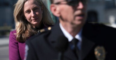 Virginia gubernatorial candidate Abigail Spanberger stands behind a police officer