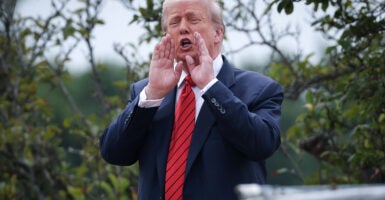 U.S. President Donald Trump shouts answers to questions from reporters as he tours the roof of the West Wing of the White House on August 05, 2025 in Washington, DC.