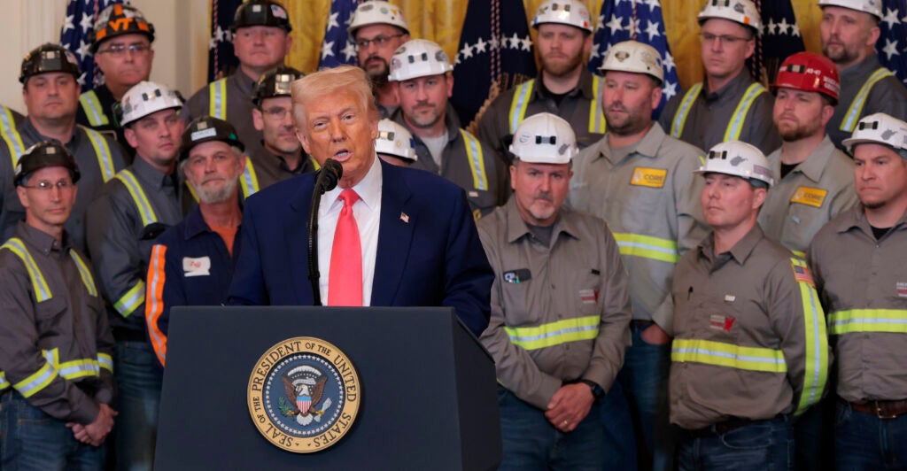 U.S. President Donald Trump speaks alongside coal and energy workers.