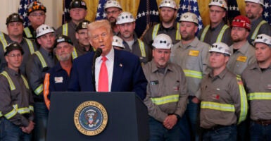 U.S. President Donald Trump speaks alongside coal and energy workers.