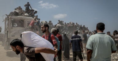 Crowds of Palestinians take food and supplies from an aid truck in northwestern Gaza.