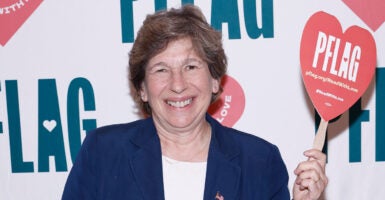 Randi Weingarten poses with a PFLAG banner