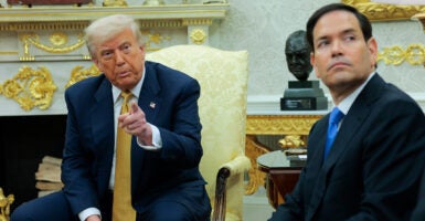 President Donald Trump and Secretary of State Marco Rubio sit in the Oval Office.