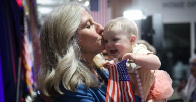 Virginia Democrat gubernatorial candidate Abigail Spanberger holds up a baby at a campaign rally and kisses her on the cheek