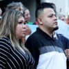 Kilmar Abrego Garcia stands next to his wife, Jennifer Vasquez Sura, while surrounded by a crowd of people.