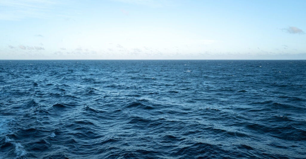 The waves in the open ocean in the middle of the day.