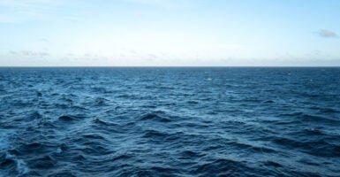 The waves in the open ocean in the middle of the day.