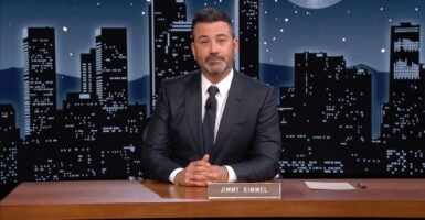 Jimmy Kimmel behind his now-suspended TV show's on-set desk with his nameplate on it