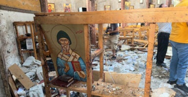 Rescue workers and civilians on June 22 inspect the aftermath of a suicide bombing at St. Elias Greek Orthodox Church in Damascus, Syria.