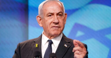Benjamin Netanyahu gestures while delivering a speech.