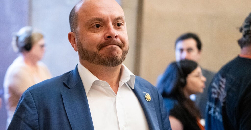 Rep. Andrew Garbarino, in blue jacket and white open collar shirt.