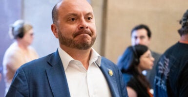 Rep. Andrew Garbarino, in blue jacket and white open collar shirt.