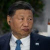 Close-up of Xi Jinping pursing his lips.