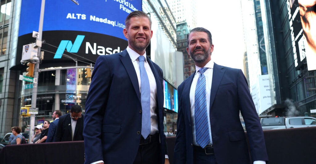 Donald Trump Jr. and Eric Trump stand together outside Nasdaq in New York Times Square.