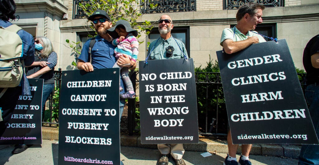 Supporters of anti-trans activist Chris Elston demonstrate against gender affirmation treatments and surgeries on minors.