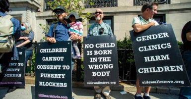 Supporters of anti-trans activist Chris Elston demonstrate against gender affirmation treatments and surgeries on minors.