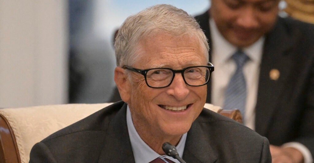 Microsoft Founder Bill Gates smiles in a suit.