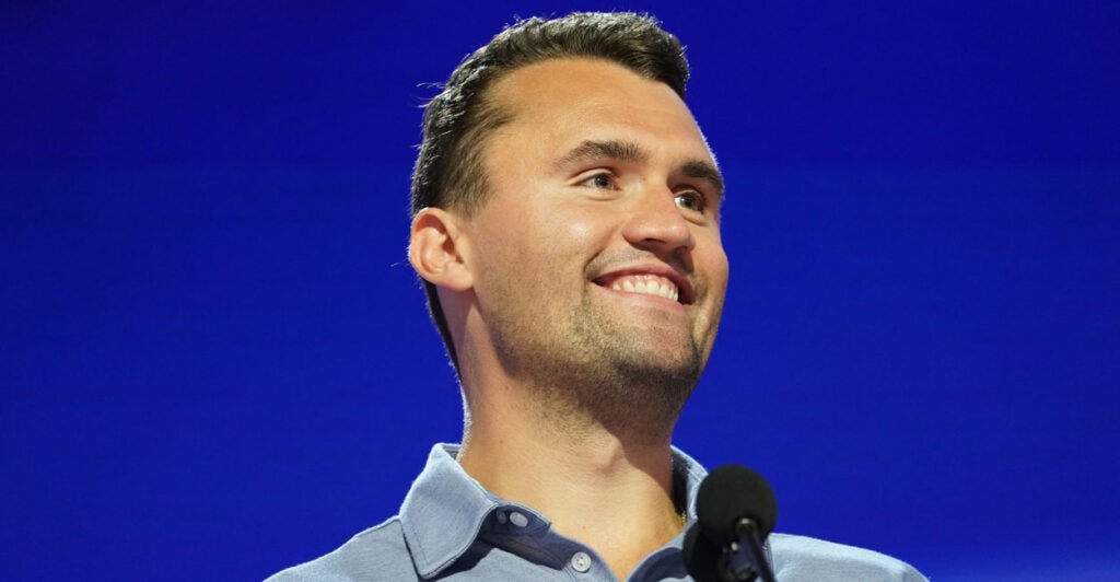 Charlie Kirk looking out over an audience and smiling