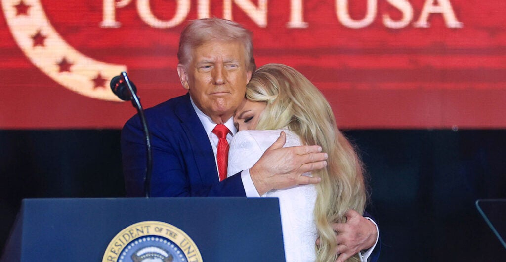 President Donald Trump embraces a tearful Erika Kirk, Charlie Kirk's widow, at his memorial service in Phoenix, Arizona.