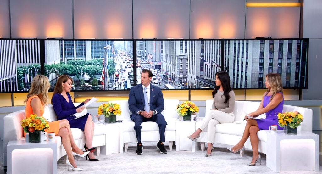 Joey Jones, Kayleigh McEnany, Dagen McDowell, Emily Compagno and Dr. Nicole Saphier are sitting on a white sofa.