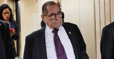 Rep. Jerrold Nadler, in dark suit, walks down a hallway in the U.S. Capitol.