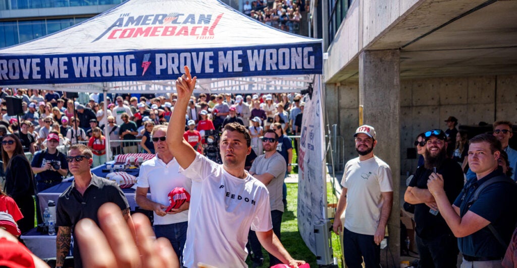 Charlie Kirk prepares to throw a hat to the crowd