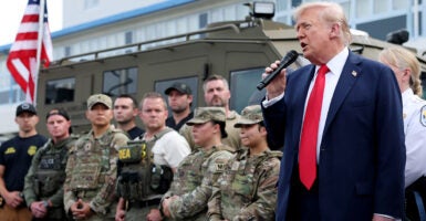 President Donald Trump flanked by some federal crimefighters